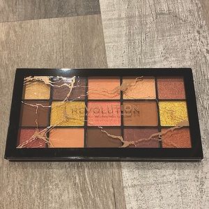 Eyeshadow pallet with golds, pinks, nudes, and browns.